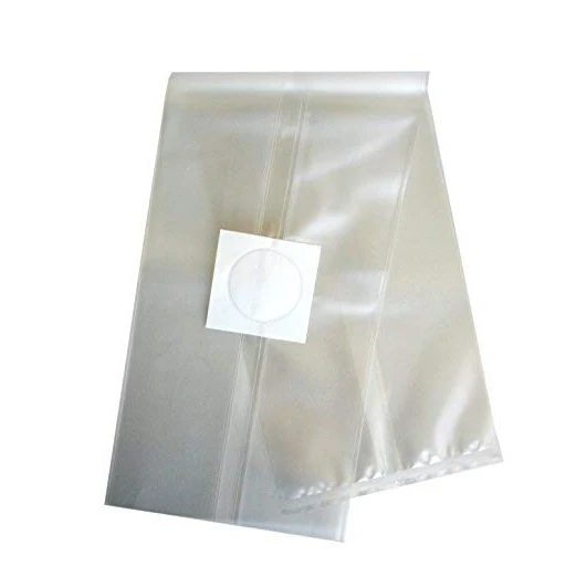 Translucent plastic liner bags stacked with a white square patch featuring a circular valve on a white background