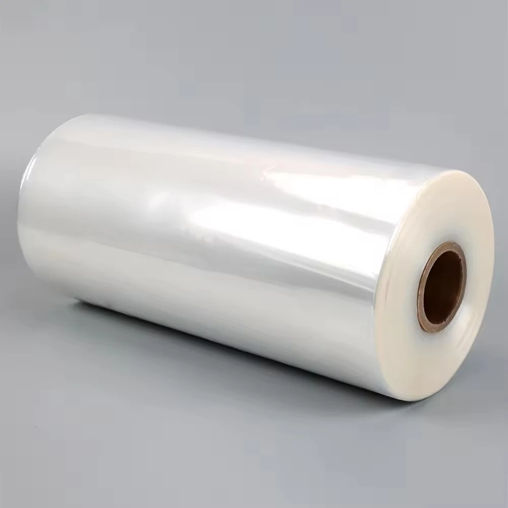Roll of clear plastic film on a cardboard core, shown diagonally against a plain grey background