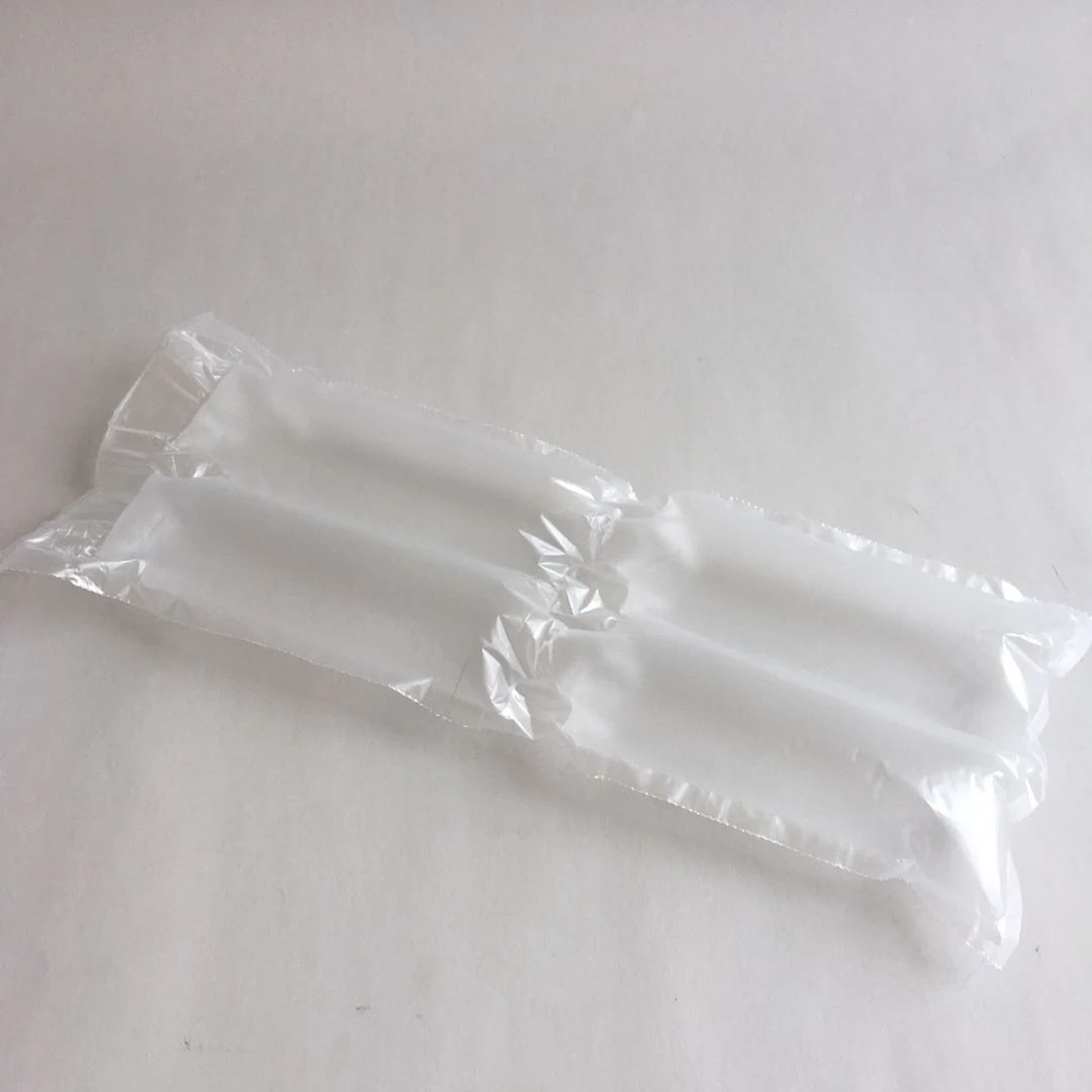Inflated translucent plastic air pillow cushion for protective packaging lying on a plain white surface