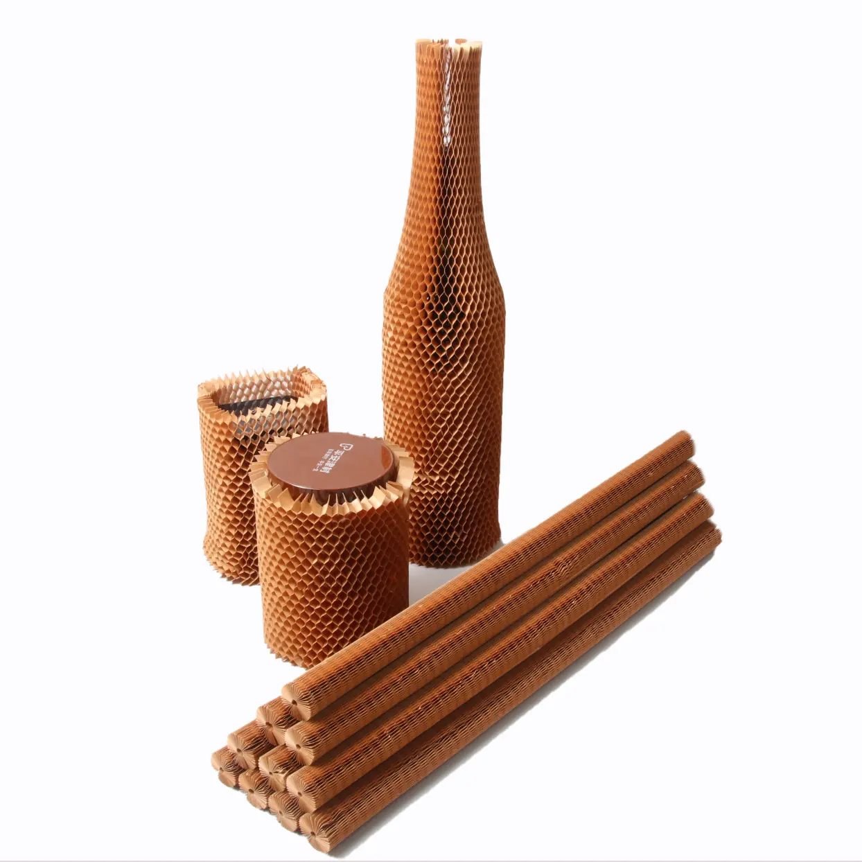 Honeycomb paper packaging material shown expanded around a bottle, jars, and rolled tubes.