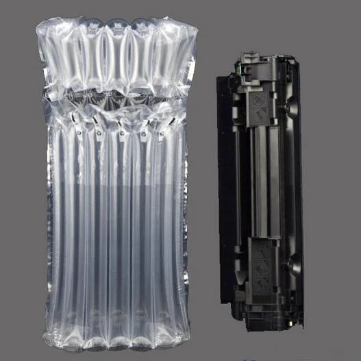 A black printer toner cartridge positioned next to a vertical clear inflatable air cushion packaging bag.