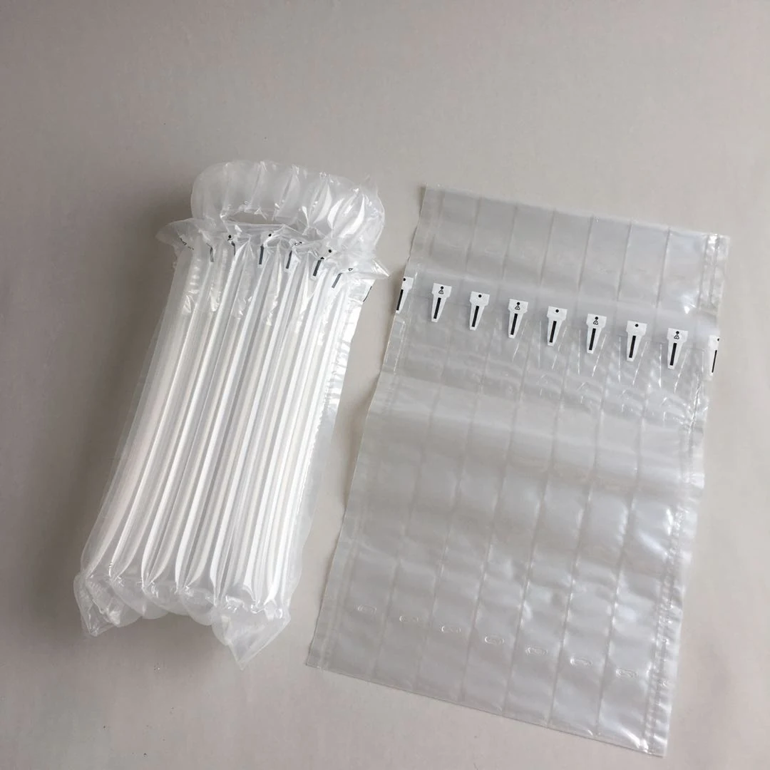 Inflated air pillow packaging beside flat air cushion wrap sheets on a plain beige surface