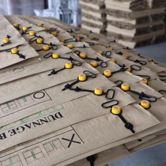 Stacks of kraft paper dunnage bags with yellow valves and black caps in a warehouse