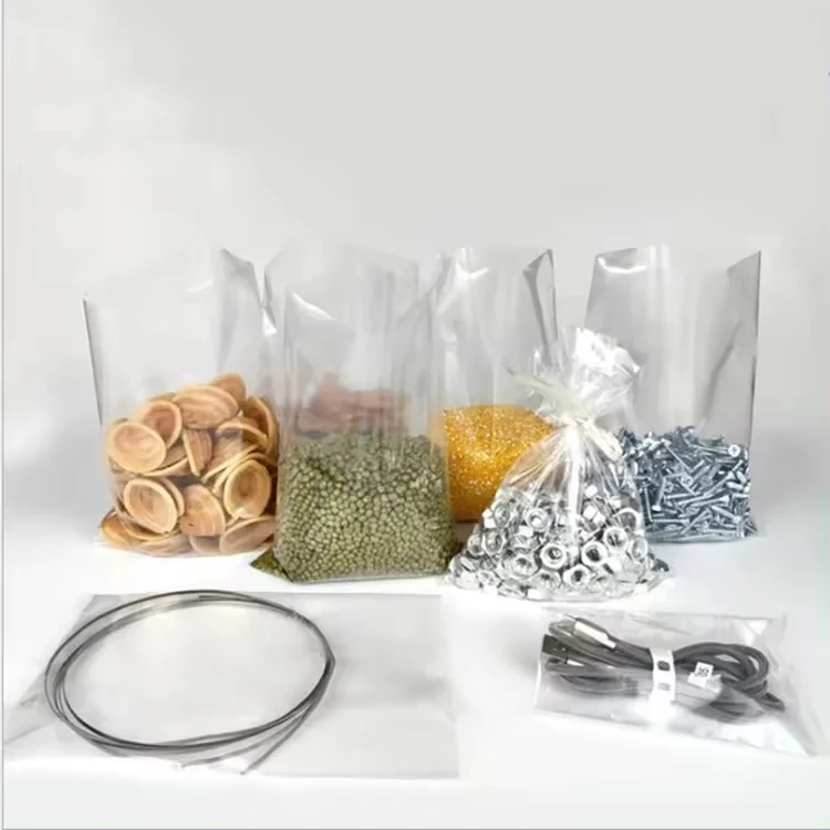 Assorted clear plastic bags filled with wooden discs, plastic granules, screws, washers, and cables on a white background
