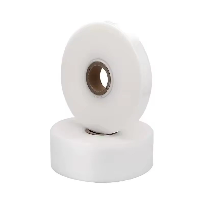 Two white tape rolls with cardboard cores, one leaning against the other, on a plain white background
