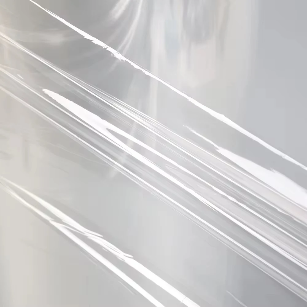 Close-up of translucent plastic film with diagonal creases and light reflections