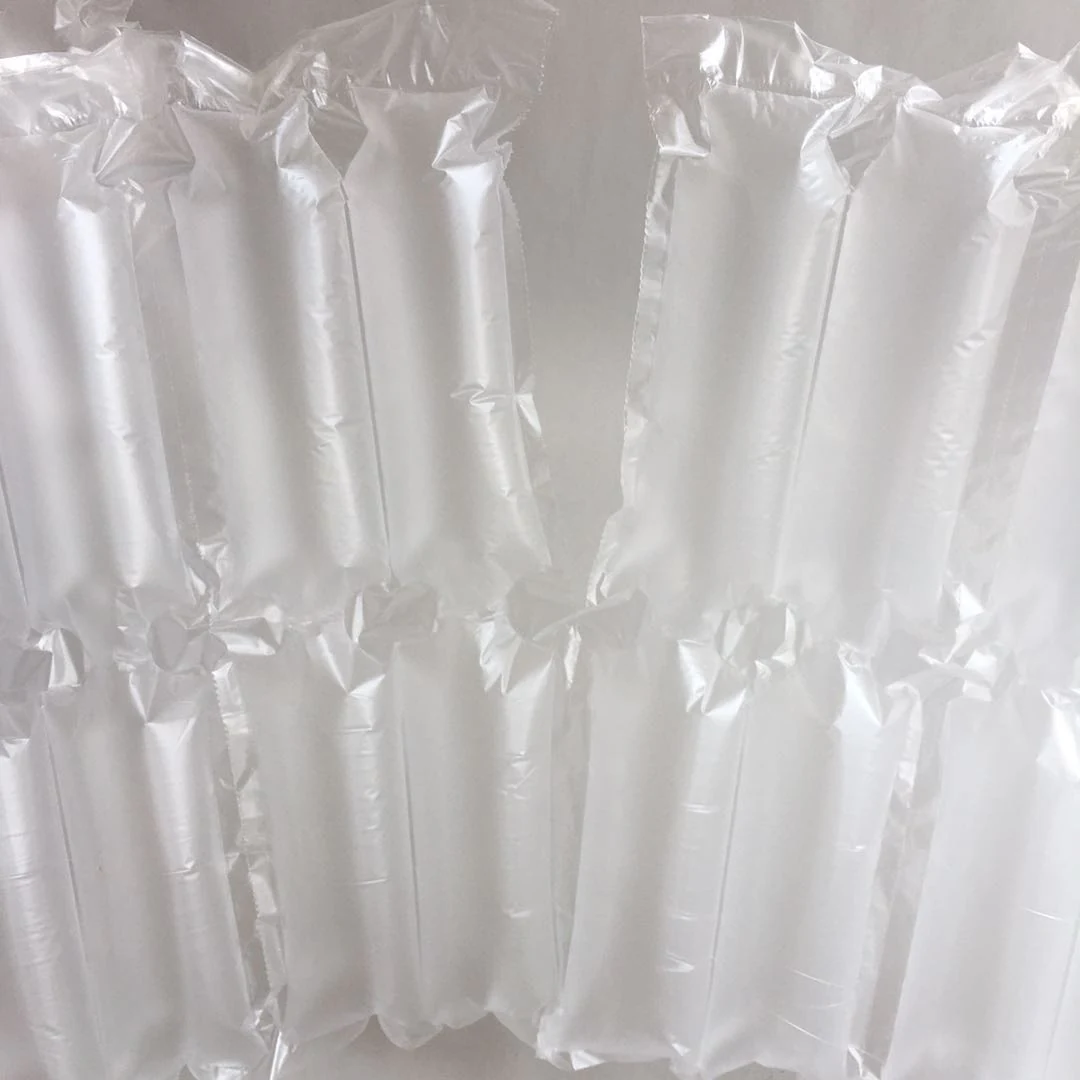 Close-up of inflated transparent plastic air pillow packaging cushions against a plain light background