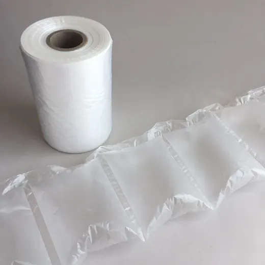 Roll of transparent air cushion film beside an inflated multi-chamber air pillow strip on a plain white background