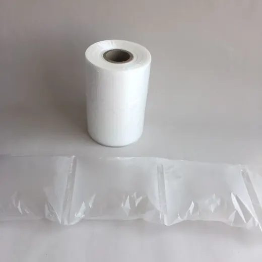 Roll of white air cushion packaging film beside a strip of inflated air pillows on a plain background