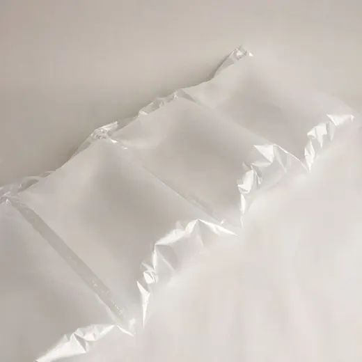 Row of connected transparent inflatable air pillow packaging cushions on a white background