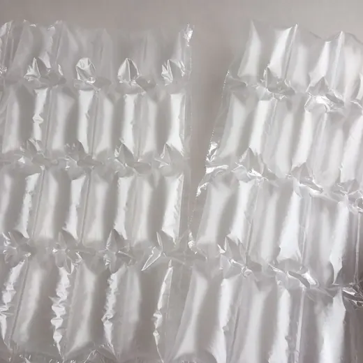 Two translucent inflatable air column packaging sheets lying flat on a plain light-colored surface