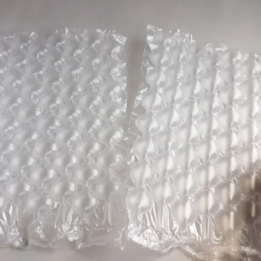 Two sheets of transparent air cushion bubble packaging lying on a plain white surface