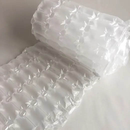 Partially unrolled roll of transparent inflatable air cushion packaging film on a plain white surface