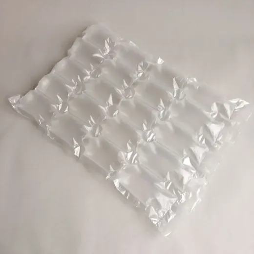 Inflated transparent air cushion packaging sheet lying flat on a plain white surface