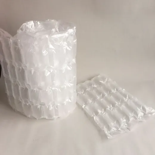 Roll of inflated air cushion packaging wrap beside a flat air column pillow sheet on a white surface