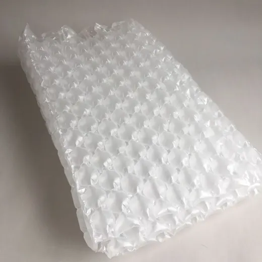 Sheet of clear bubble wrap air cushion packaging on a plain light background