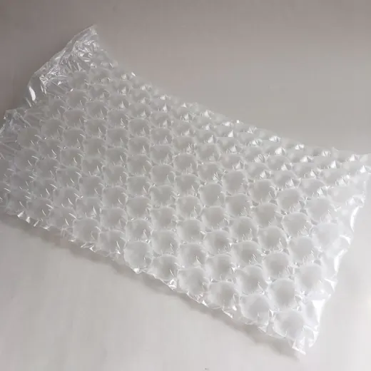 Inflated clear air cushion packaging pillow lying flat on a white surface