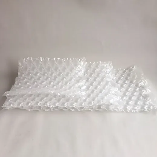 Sheets of clear bubble wrap packaging material lying flat on a white surface