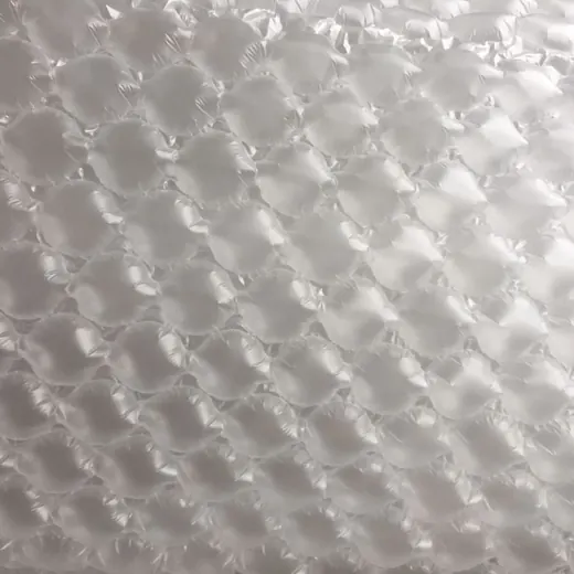Close-up of translucent bubble wrap showing rows of air-filled plastic bubbles filling the frame