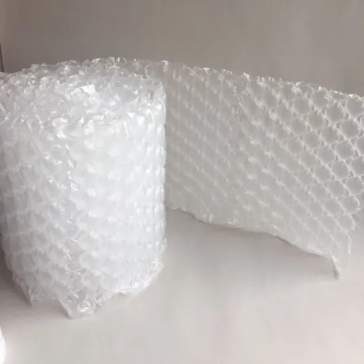 Roll of clear bubble wrap, partially unrolled, on a plain white surface and background