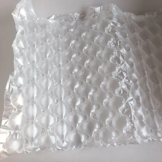 Close-up of transparent bubble wrap air cushion packaging sheet on a plain white background