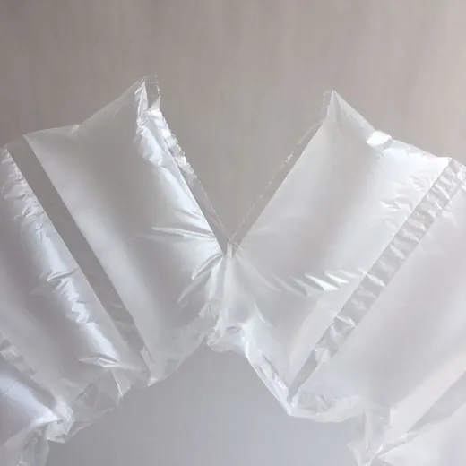 Translucent white inflatable air pillow void-fill packaging on a plain light background