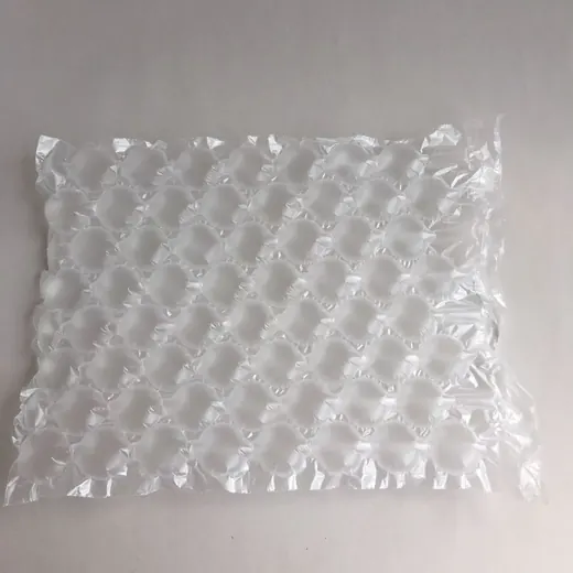 Translucent air cushion packaging sheet with rows of inflated bubbles on a plain light background