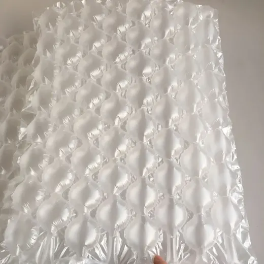 Close-up of translucent white inflatable air cushion packaging film draped in front of a plain white wall