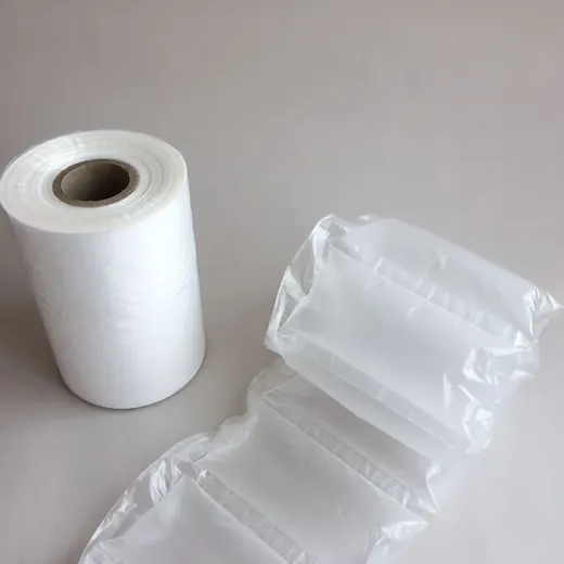 Roll of inflatable air pillow packaging film beside inflated air cushion pillows on a plain light background