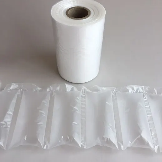 Roll of translucent air cushion film beside a strip of inflated air pillow packaging on a light background