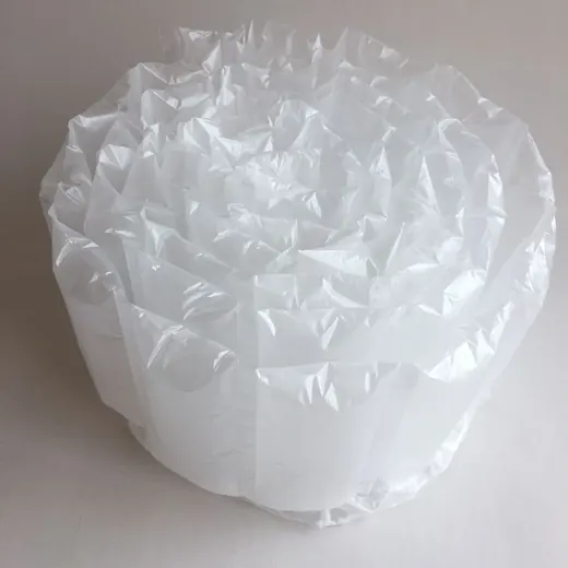 Coiled roll of inflated transparent air cushion packaging film on a plain white background