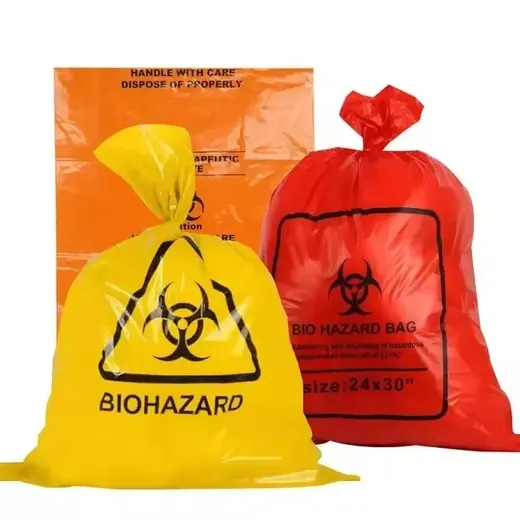 Yellow and red biohazard bags filled and tied, displayed with a flat orange bag behind them