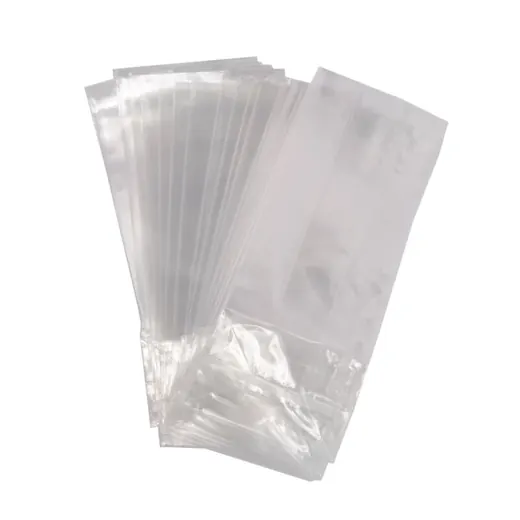 Fan of clear flat plastic bags spread out on a plain white background