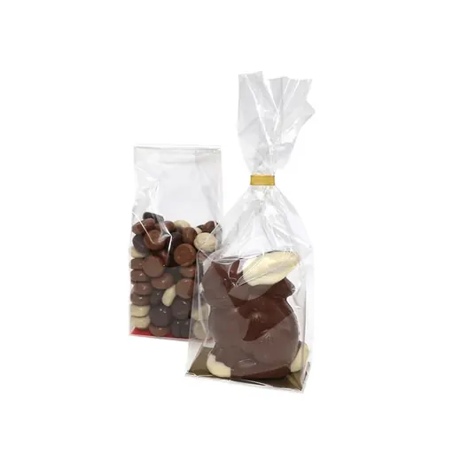 Two clear cellophane bags filled with chocolate sweets and a chocolate Easter bunny on a white background