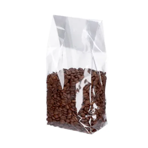 Clear cellophane bag filled with roasted coffee beans on a white background