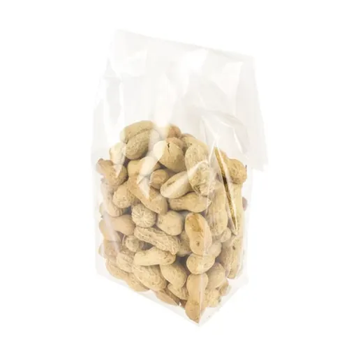Transparent plastic bag filled with in-shell peanuts on a white background