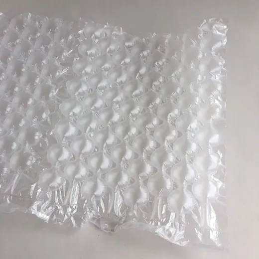 Close-up of transparent bubble wrap air cushion packaging on a plain light background