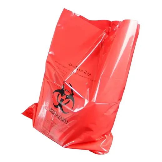 Red biohazard autoclave waste bag with printed symbol, isolated on a white background