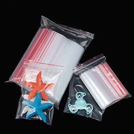 Stacks of clear plastic ziplock bags with red strips alongside small bags containing starfish and fidget spinner