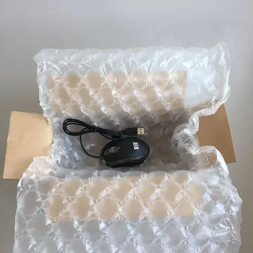 Electronic devices packed with protective air cushioning