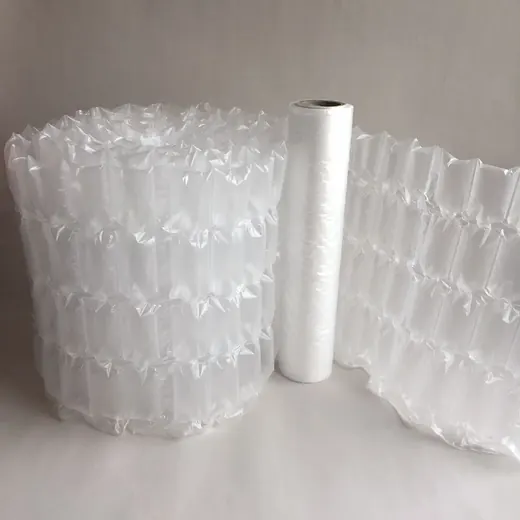 Roll of inflated air cushion packaging material beside a white film roll on a plain light background