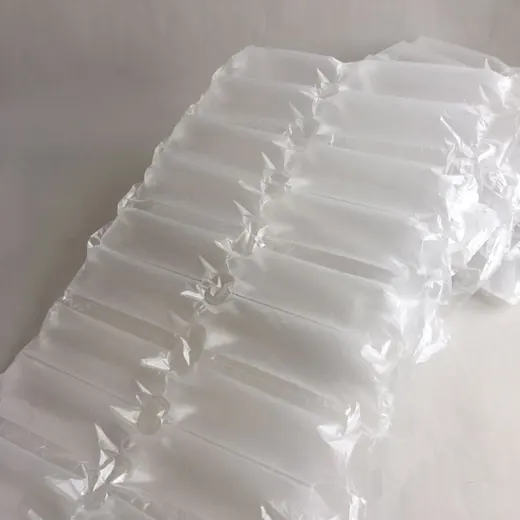Rows of inflated clear plastic air pillow packaging cushions on a white surface