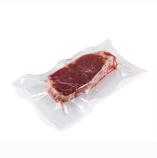 Vacuum-sealed raw beef steak in clear plastic packaging on a white background.
