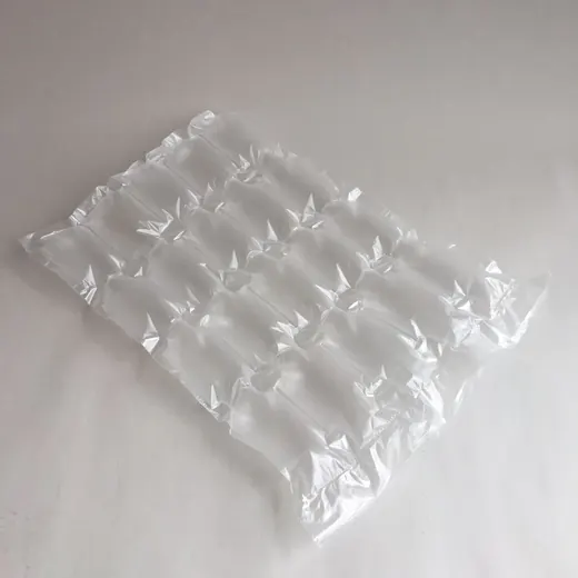 Transparent inflatable air cushion packaging sheet resting on a plain white surface