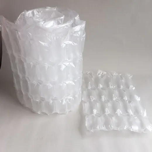 Roll and sheet of clear inflatable air cushion packaging on plain background