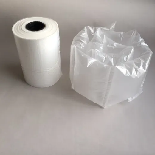 Roll of white air cushion film next to an inflated plastic air pillow on a plain white background