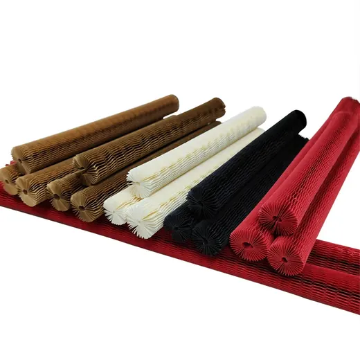 Pleated paper or filter media rolls in brown, white, black, and red arranged on a white background