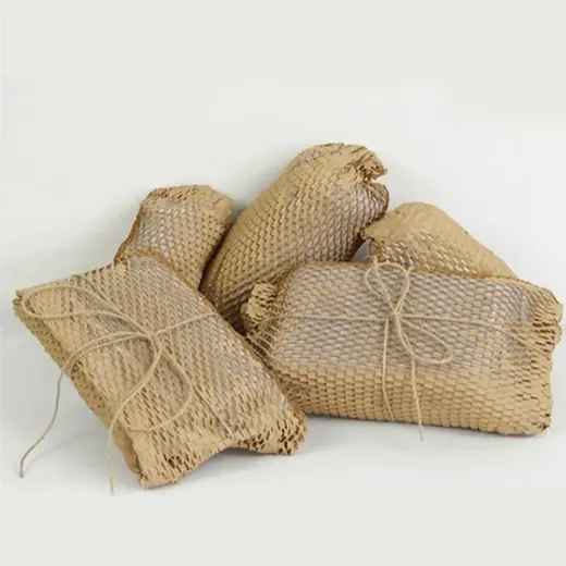 Several items wrapped in kraft honeycomb paper packaging tied with twine on a white background
