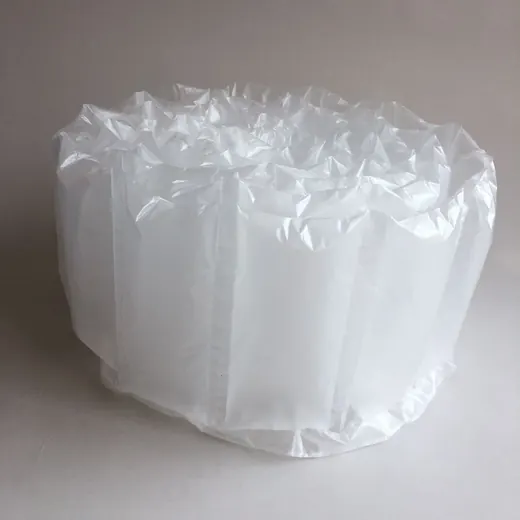 Inflated white air cushion packaging pillows arranged in a pile on a plain light background
