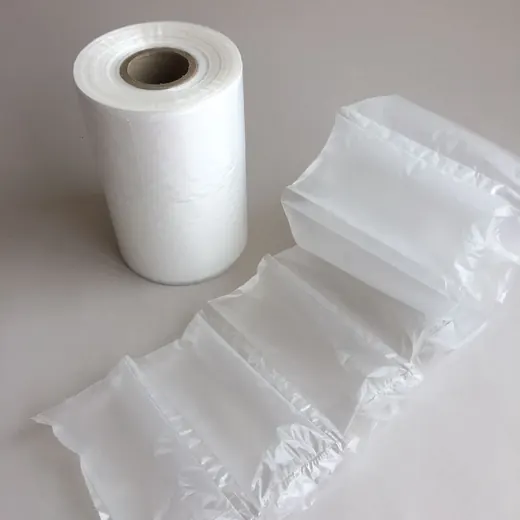 A roll of white plastic film next to a strip of inflated air cushions on a gray background